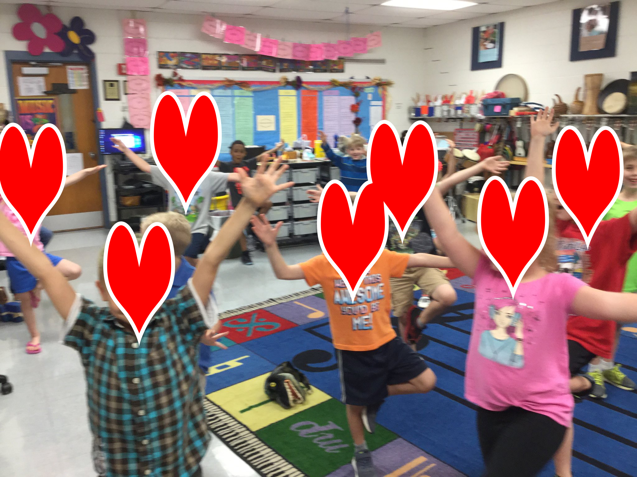 First grade students doing yoga poses from Yoga Pretzels pose cards
